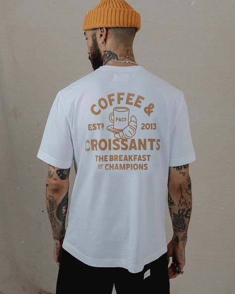 Coffee & Croissants T-shirt in off-white. Perfect for a lazy Sunday morning or a day at the cafe. #coffee #croissant / #Mens_Printed_T_Shirts_Graphic_Tees #White_Tee_Graphic #Men_T_Shirt_Design_Ideas #Coffee_T_Shirt_Design Mens Printed T Shirts Graphic Tees, White Tee Graphic, Men T Shirt Design Ideas, T Shirt Men Style, T-shirt Designs, Screen Printing T Shirt, Coffee T Shirt Design, Coffee Shirt Design, Mens Graphic Tees Prints