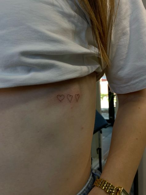 Small Heart Tattoo Back Of Arm, Heart Under Chin Tattoo, Tattoo Over Heart Placement, Cluster Of Hearts Tattoo, Heart Warrior Tattoo, Heart Collar Bone Tattoo, Heart Rib Tattoo, Heart Hip Tattoo, Drawn Heart Tattoo