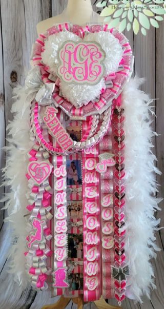 Barbie Mums Homecoming, Hot Pink Mums Homecoming, Senior Year Mums, Hoco Mums Ideas, Senior Festivities, Pink Homecoming Mum, Senior Painted Jeans, Hot Pink Homecoming, Heart Mum