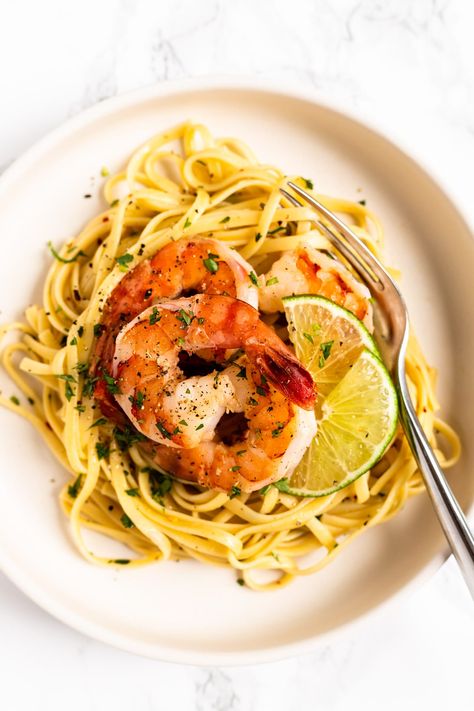 Linguini tossed in a white wine, garlic and butter sauce with lime juice and cilantro then topped with seasoned shrimp. This light and refreshing cilantro lime shrimp pasta is a quick and easy meal you'll want to eat again and again! Salmon Pesto Pasta, Salmon Pesto, Seasoned Shrimp, Chili Lime Shrimp, Creamy Garlic Mushrooms, Cilantro Lime Shrimp, Garlic Shrimp Pasta, Pesto Salmon, Creamy Garlic Sauce