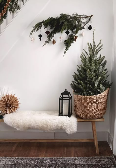 21 Scandi Christmas Decor Ideas for Your Coziest Holiday Yet Christmas Tree In A Basket, Scandi Christmas Decor, Switzerland Home, Scandi Winter, Scandi Christmas Decorations, Christmas Hallway, Rustic Christmas Tree Ideas, Chic Halloween Decor, Charlie Brown Tree