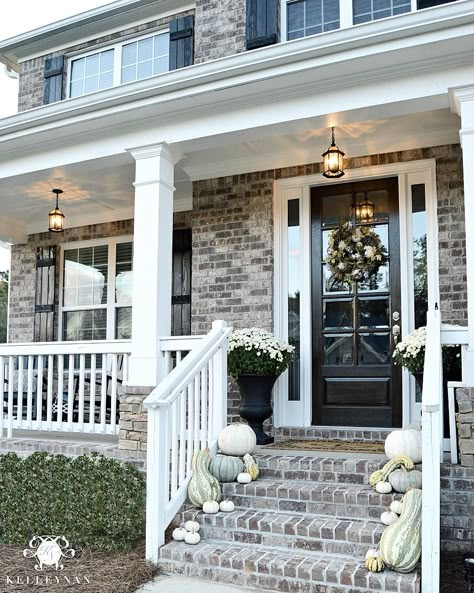 Kelley Nan (@kelleynan) • Instagram Neutral fall front porch with white and cinderella pumpkins and gourds | white mums in black urns on either side of front door | white raining on brick front porch KELLEYNAN.com Brick Farmhouse Exterior, Brick Farmhouse, Brick Porch, Brick Steps, Glass Railings, House Paint Color Combination, Exterior Front Doors, Porch Steps, Front Steps