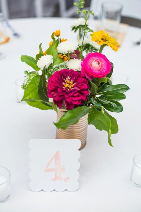 Tin can centerpiece with zinnias and ranunculus Flower Arrangements Mason Jars, Zinnia Flower Arrangements, Zinnia Wedding Flowers, Zinnia Wedding Bouquet, Zinnia Wedding, Tin Can Centerpieces, Zinnia Bouquet, Short Centerpieces, Red Centerpieces