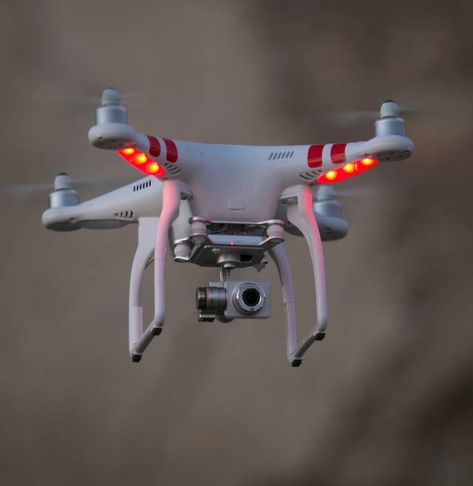 A Phantom drone buzzes above Gaviota State Beach at sunset on November 26, 2014, in Santa Barbara, California. Gadget Tecnologici, Mobile Software, Phantom Drone, Professional Drone, Flying Drones, Aerial Photography Drone, Uav Drone, Drones Concept, New Drone