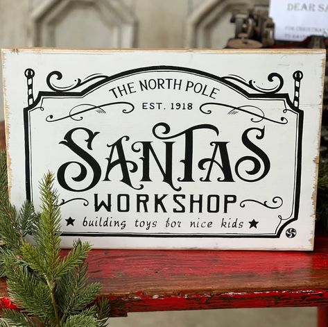 This wonderfully sized and distressed wooden Santa's Workshop Sign is sure to add a festive touch to your holiday decor. Crafted with a classic, vintage look in a charming font, it's sure to bring a smile to the faces of your family and guests. We have it leaning on a tabletop easel (not included) or can be hung Dimensions: 15.75"w x 10.5"h Materials: wood, metal hangers Santa's Workshop Sign, Disney Christmas Stockings, Workshop Sign, Hogwarts Christmas, Tabletop Easel, Scrap Wood Crafts, Heart Christmas Ornaments, Wood Pallet Wall, Wooden Santa