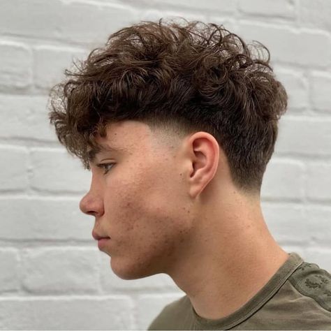 50 Best Short Wavy Hairstyles for Men in 2023 Side Fade Curly Hair Men, Wavy Hairstyles Men Fade, Mens Taper Fade Haircut Medium, Side Cute Hairstyles Men, Mens Taper Haircut Medium, Side Taper Fade, Mowhak Hairstyle For Boys, Faded Sides Long Top Men's Hairstyle, Side Fade Haircut Men Medium Long