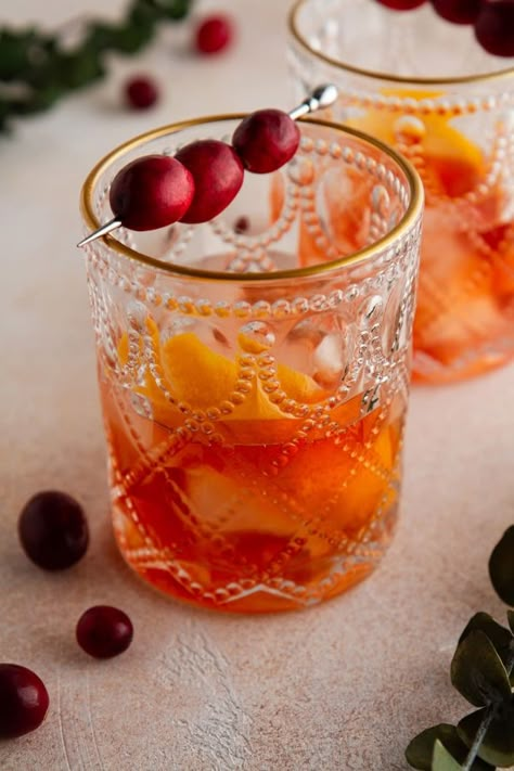 Make your favorite classic cocktail extra-festive with this Cranberry Old Fashioned! Homemade cranberry simple syrup gives this drink added flavor and spice. Perfect for the holidays! Spiced Cranberry Syrup, Drinks With Cranberry Simple Syrup, Cranberry Old Fashioned Cocktails, Cranberry Old Fashioned, Cranberry Simple Syrup Cocktail, Cranberry Simple Syrup, Simple Syrup Cocktails, Cinnamon Simple Syrup, Christmas Drinks Recipes