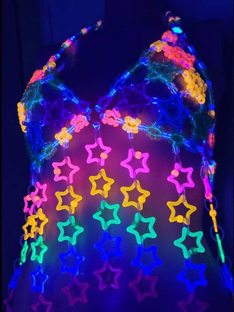 Unleash your inner star with the Glitter Star Kandi Harness! This dazzling festival outfit is a showstopper, featuring a mesmerizing kandi bra adorned with sparkling glitter stars. It’s the perfect rave clothing to elevate your style and make you shine on the dance floor. Get ready to slay in this gogo-inspired festival top! Glitter Star Kandi Harness on GlowInTheDarkStore.com Kandi Bra, Kandi Harness, Festival Kandi, Kandi Ideas, Glow Stars, Fishnet Bodysuit, Star Clothing, Rave Clothing, Dark Outfits