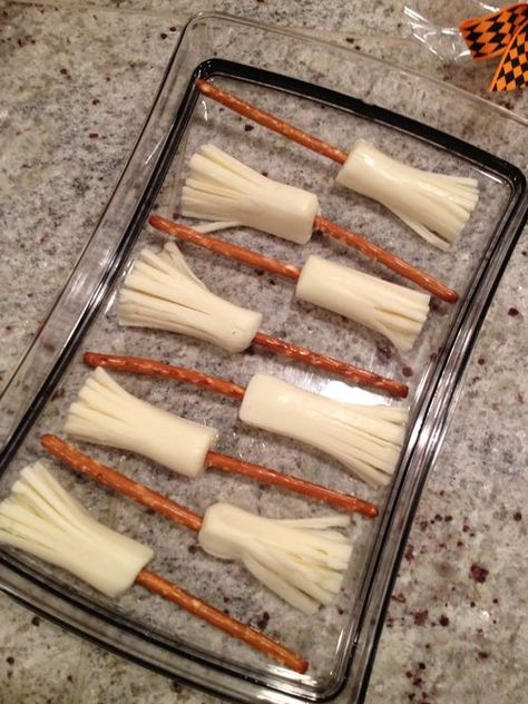 Pretzel Rods and String Cheese are all you need to make these adorable Broom Sticks. What a nutritious, fun treat for snacks or parties. The trickiest step will be stringing the cheese to give it that broom straw affect. Snack Halloween, Postres Halloween, Recetas Halloween, Kid Games, Healthy Halloween Treats, Healthy Halloween Snacks, Halloween Week, Preschool Snacks, Halloween Spooktacular