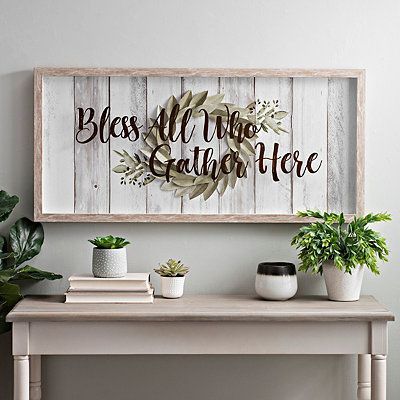 Give your decor a rustic feel with our Gather Here Wreath Panel Shadowbox. The glass printed typography and distressed backing will fit right into your home! Framed print measures 37.25L x 1.25W x 17.25H in. Print measures 35.75L x 15.75H in. Frame crafted of polystyrene Whitewashed woodgrain frame finish Features the phrase "bless all who gather here" printed on glass Panel backing has faux shiplap and wreath accent Hues of white, tan, gr Faux Shiplap, Farmhouse Decor Living Room, Decoration Inspiration, Modern Farmhouse Decor, Contemporary Home Decor, Farmhouse Wall Decor, Farmhouse Wall, Farmhouse Living, Rustic Diy