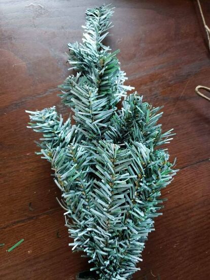 I have a cute and quick little project for you today - a Christmas swag using 2 Dollar Tree mini Christmas trees. This is such an easy and inexpensive Christmas DIY! You can run to the Dollar Store and do this project today! Let's get started. To make a Christmas swag you're going to need two of the mini Christmas trees from Dollar Tree. I used white spray paint to lightly paint my tree branches to look like snow. Be sure to check out my blog post on other suggestions for this.… Mini Christmas Tree Diy, Dollar Tree Flowers, Full Christmas Tree, Mini Christmas Trees, Diy Mailbox, Farmhouse Fall Wreath, Swag Ideas, Inexpensive Christmas, Christmas Swag