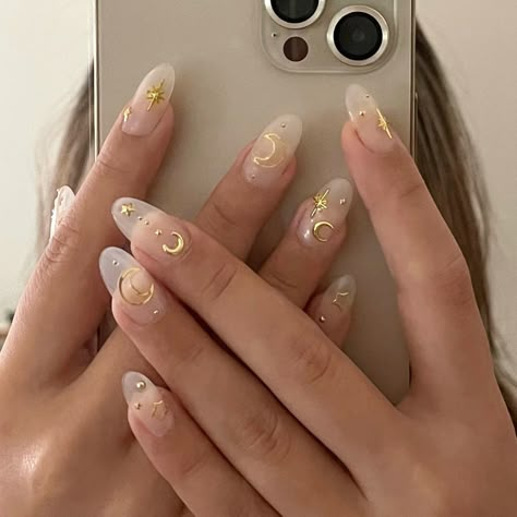 Clear and nude base with moon and star gems and details Pinterest: @ambxlx IG: @ambxlx Clear Nails Gold Design, Moon Stars Nail Design, Acrylic Nail Designs Stars And Moon, Gold Stars And Moon Nails, Moon And Stars Manicure, Stars Moon Nails, Sun And Star Nails, Nail Moon Designs, White Celestial Nails