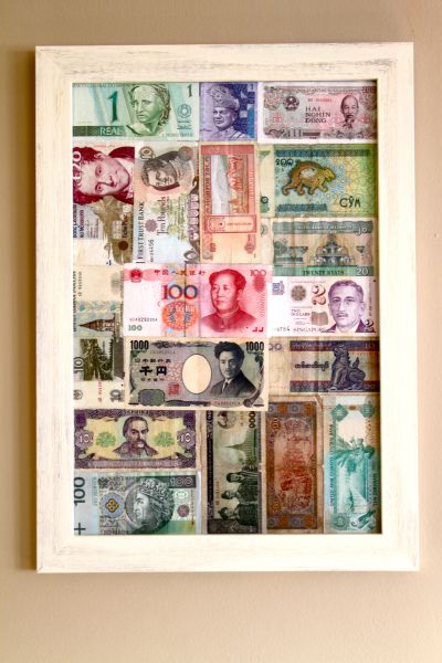 The foreign money jar gets some inspiration | Cultural Jet Lag Foreign Money, Travel Photos Display, Souvenir Display, Travel Room, Travel Crafts, Money Jars, Coin Display, Travel Keepsakes, Travel Wall