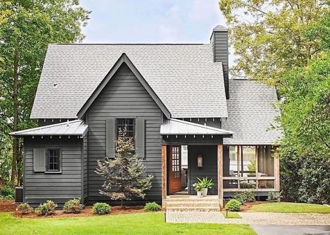 “There’s just something so cozy about a house that’s tucked into the trees by a lake,” says interior designer Lilly Taylor. And this secluded home on the banks of an Alabama lake is just that. A balancing act between modern and nautical touches, light and dark, and old and new, the design of this lakeside hideaway was made to accentuate the surrounding natural beauty. Small Lake Houses Exterior, River Cottage Exterior Colors, Lake Cottage Addition, Grey Lake House Exterior, Mountain Cottage Exterior Paint Colors, Alabama Lake House, Shingle Style Lake House, Lakeside Cottage Exterior, Lake House Bungalow