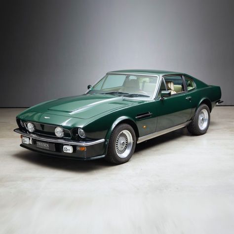 The Aston Martin V8 Vantage appeared in February 1977 as a performance-enhanced version of the V8. Externally, it was recognisable by deep front skirts, a clad radiator grille with recessed auxiliary headlights, widened wheel arches and a spoiler integrated into the tailgate. Optimised engines up to the X-Pack specification from 1986 offered outputs of up to 432 hp and made the car the fastest production vehicle of its time! Aston Martin Vintage Cars, Aston Martin V8 Vantage 1977, Vintage Aston Martin, Classic Aston Martin, Austin Martin, Aston Martin V8 Vantage, V8 Vantage, Fiat 850, Aston Martin V8