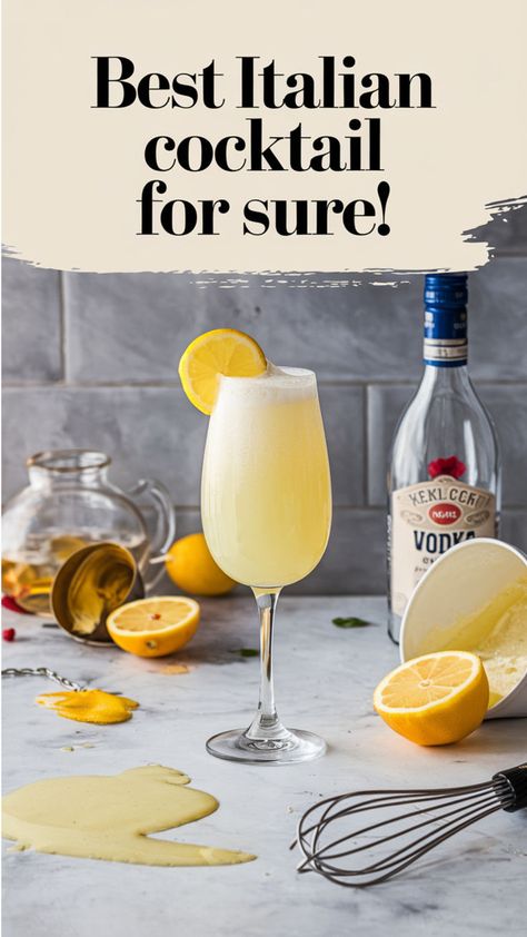 This image highlights a creamy, lemon-infused Italian cocktail served in a champagne flute, garnished with a lemon slice. The text, "Best Italian cocktail for sure!" suggests this is a standout drink, possibly a variation of a Limoncello-based cocktail or another citrus-forward Italian creation, ideal for any occasion. Italian Alcoholic Beverages, Italian After Dinner Drinks, Italian Inspired Cocktails, Italian Drinks Alcohol Cocktails, Italian Drinks Alcohol, Italian Drink Recipes, Mediterranean Cocktails, Italian Cocktail Recipes, Italian Drinks