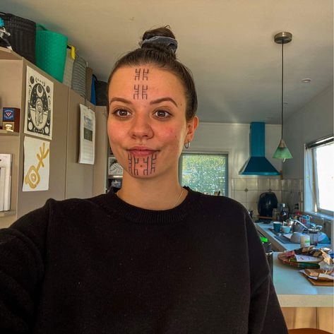 a young Australian-Motu woman of mixed Papua New Guinean and white heritage smiles proudly at the camera. she has facial tattoos in a Papua New Guinean cultural style. Christian Tattoos For Women, Tattoos Face, Proud Of My Daughter, Australian Tattoo, Face Tattoos For Women, Christian Missionary, Tattoo Face, Western Tattoos, Country Singer