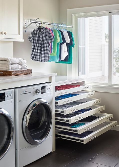 Stacked pull out drying racks are hidden behind white drawer fronts accented with satin nickel pulls and are positioned beneath a drying rod. Laundry Room Drying Rack, Laundry Room/mud Room, Drying Room, Dream Laundry Room, Mudroom Laundry Room, Laundry Room Layouts, Laundry Design, Drying Rack Laundry, Laundry Room Inspiration