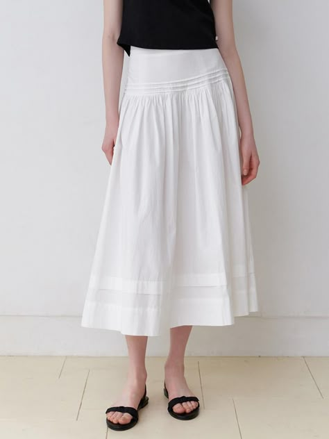 This garment is a long, flowing skirt with a wide waistband. It features gathered detailing below the waistband, which adds volume and a feminine silhouette. The skirt has a smooth, uninterrupted hemline, suggesting a seamless and clean finish. This piece falls gracefully and is likely designed to provide both comfort and elegance. - The skirt has a wide, flat waistband for a smooth fit.- Gathered details beneath the waistband create a fuller appearance.- Its length and fluid drape suggest ... White Long Skirt, Tailored Clothes, Long Skirt Outfits, Muslim Fashion Hijab, Feminine Silhouette, Flowing Skirt, Skirt White, W Concept, Gathered Skirt