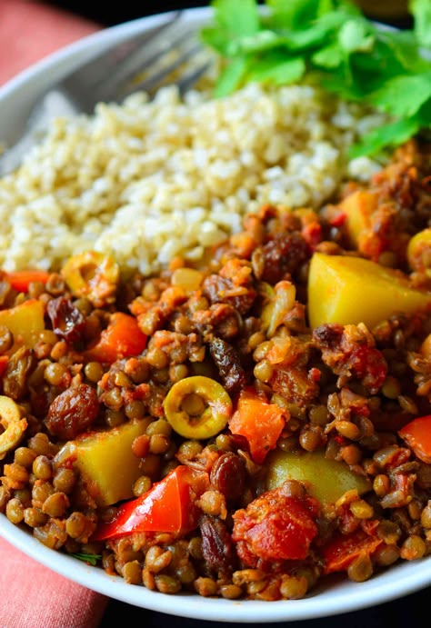 This vegan picadillo recipe is a delicious and colourful Cuban-style dish of spiced lentils, potatoes, tomatoes, olives and raisins. Served with rice, it’s quick and easy to prepare for a weeknight dinner and the warming spices of cinnamon, cumin, cloves and nutmeg make it a comforting and hearty meal for chilly weather. Vegan Picadillo, Picadillo Recipe, Potatoes Tomatoes, Spiced Lentils, Lentil Recipes, Seitan, Meatless Meals, Hearty Meals, Vegan Life