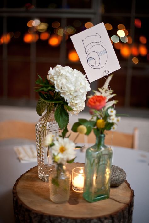 hand-drawn table numbers // photo by NinePhotography.com Vintage Glass Vases Wedding, Assorted Glasses Wedding, Random Glass Centerpieces, Vintage Glass Centerpieces, Vintage Glassware Wedding Centerpieces, Decanter Wedding Centerpiece, Vintage Vases Centerpieces, Decanter Centerpiece, Glass Bottle Centerpieces