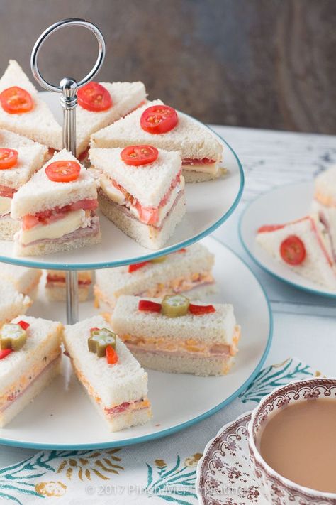 These adorable ham and pimento cheese tea sandwiches would be perfect for a Southern tea party or afternoon tea! And they're topped with the cutest pickled okra garnishes! Party Snacks For Adults, Recept Sandwiches, Tea Party Sandwiches Recipes, Snacks For Adults, Southern Tea, Cheese Tea, Tea Party Sandwiches, Tea Sandwiches Recipes, Pickled Okra