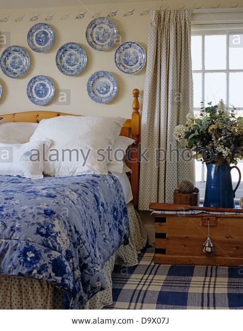 Collection of blue and white china plates on wall above bed with white pillow and blue Blue And White Plates On Wall Bedroom, Blue And White China Bedroom, Plates Over Bed, Plates Above Bed, China Plates On Wall, Blue And White Plates On Wall, Wall Above Bed, Feminine Bedrooms, Hang Plates On Wall