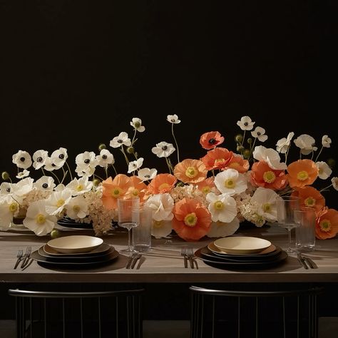 A modern dining table with plates and glasses and an elegant floral centerpiece, the flowers are poppies and anemones arranged in a gradient that transitions smoothly from left to right going from pure white at one end to deep orange at the other Poppy Arrangement Floral Design, Anemone Centerpiece Table Arrangements, Anemone Floral Arrangements, Anemone Table Arrangement, Anemone Flower Arrangement, Poppies Arrangement, Anemone Arrangement, Anemone Centerpiece, Elegant Logos