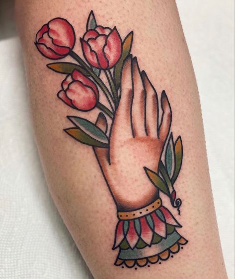 Tradition Hand Tattoo, Trad Tattoo Hand, American Traditional Tulip, American Traditional Tulip Tattoo, Tulip Tattoo Traditional, Pinwheel Flower Tattoo, Traditional Tattoo Hand Holding, American Traditional Floral, Hand Holding Flower Tattoo