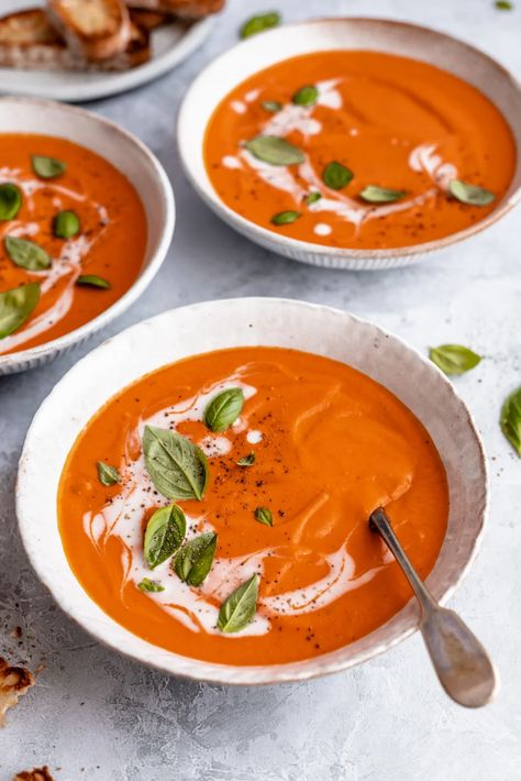 Creamy vegan tomato soup using canned tomatoes and delicious coconut milk to give it the perfect texture and a hint of sweetness. This comforting, easy vegan tomato soup recipe gets a wonderful boost of flavor from caramelized onions and is the perfect lunch or dinner with your favorite crackers, garlic toast and anything your heart desires. #veganrecipe #tomatosoup #vegansoup #coconutmilk #plantbased #dairyfree #healthylunch #healthydinner Souper Bowl, Soup Store, Vegan Tomato Soup, Garlic Toast, Canned Tomatoes, Ambitious Kitchen, Seasoning Salt, Tomato Soup Recipes, Perfect Lunch