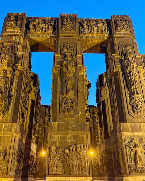 The Chronicle of Georgia (or History Memorial of Georgia) is a monument located near the Tbilisi sea. It was created by Zurab Tsereteli in 1985 but was never fully finished. The monument sits at the top of a large set of stairs. There are 16 pillars that are between 30–35 meters tall and the top half features kings, queens and heroes while the bottom part depict stories from the life of Christ. There is a grapevine cross of St. Nino and a chapel. Chronicles Of Georgia, Travel Georgia, Life Of Christ, Art Deco Architecture, Eiffel Tower Inside, Us Army, Eiffel Tower, Monument, Georgia