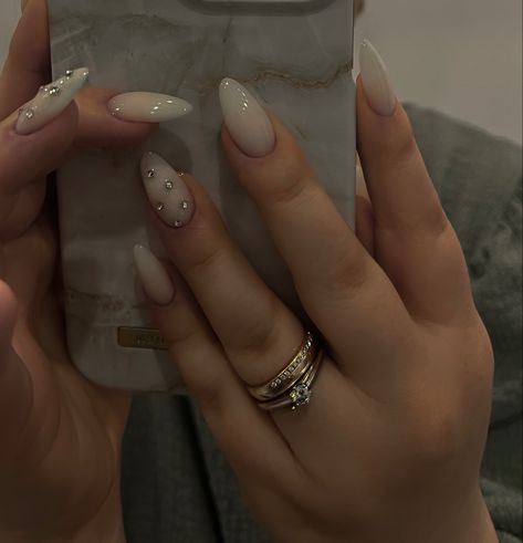 Trendy Milky Nails, Milky Nails Design Almond, Nails With Rhinestones On One Nail, Simple Nail Designs Milky White, Milky White Nails Rhinestones, Almond Powder Nails, Milky White Nails With Bling, Short Almond Milky Nails, Milky White Nails Acrylic Design Almond