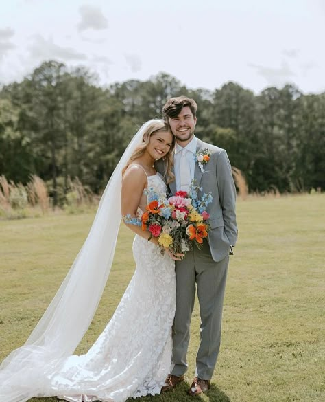 Bride And Groom Summer Wedding, Spring Wedding Suits For Groom, Wildflower Wedding Groom Suit, Groomsmen Attire Wildflower, Pastel Wedding Theme Groomsmen, Spring Wedding Tuxedo, Groom Spring Wedding Attire, Groomsmen Wildflower Wedding, Wildflower Wedding Suit