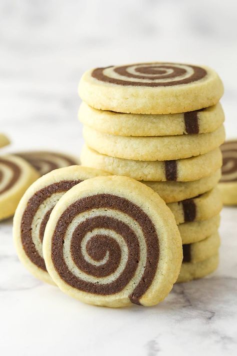 These pinwheel cookies are sure to turn heads. They're made up of two flavors of cookie dough (chocolate and vanilla) rolled together into a log, sliced, and then baked into whimsical spiral cookies. Checkerboard Cookies, Pinwheel Cookies, Unsweetened Chocolate, Vanilla Cookies, Chocolate Ice, Orange Recipes, Chewy Cookie, Chocolate Ice Cream, Vegetarian Chocolate