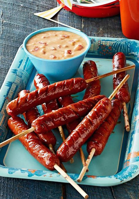 Dip hot dogs on a stick into queso sauce plus 15 genius hot dog hacks! Hot Dog On A Stick, Queso Sauce, Brats Recipes, Hot Dog Recipes, Grill Recipes, Kraft Recipes, Fun Foods, On A Stick, Party Foods