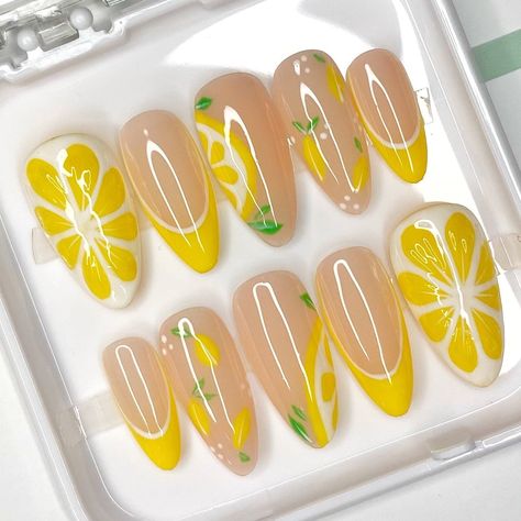 Hi 𝕭𝖆𝖇𝖊𝖘! ✨ Thank you for checking out our product 💜💚 Set details : Summer nail art collection 🌼🍋 Big 3d lemon on thumb, lemon nail art with leaves and yellow French tips. Shiny top. Included with your order: 10 hand-painted press on nails, prep application kit and a small gift 💖 To fit your nails perfectly we recommend purchasing a sizing kit.  You can always follow the measure guide to provide us with a size or a custom sizes of your nails in mm. 𝗜𝗺𝗽𝗼𝗿𝘁𝗮𝗻𝘁 - We will not be r Summer Nails Designs Fruits, Lemon Nail Art Designs, Yellow Aesthetic Nail Designs, Yellow Fake Nails, Summer Fruit Nail Designs, Cute Lemon Nails, Yellow Press On Nails, Food Themed Nails, 3d Lemon Nails