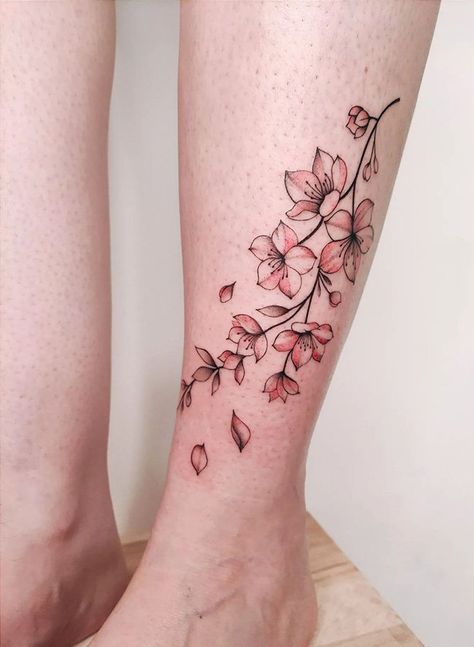 100 Elegant Cherry Blossom Tattoos (Most Unique Gallery) - The Trend Scout Cherry Blossom Wrap Tattoo, Cherry Blossom Finger Tattoo, Cherry Blossom Tattoo Leg, Blossom Ankle Tattoo, Japanese Cherry Blossom Tattoo Design, Cherry Blossom Wrist Tattoo, Cherry Blossom Leg Tattoo, Cherry Blossom Sleeve Tattoo, Japanese Tattoo Cherry Blossom