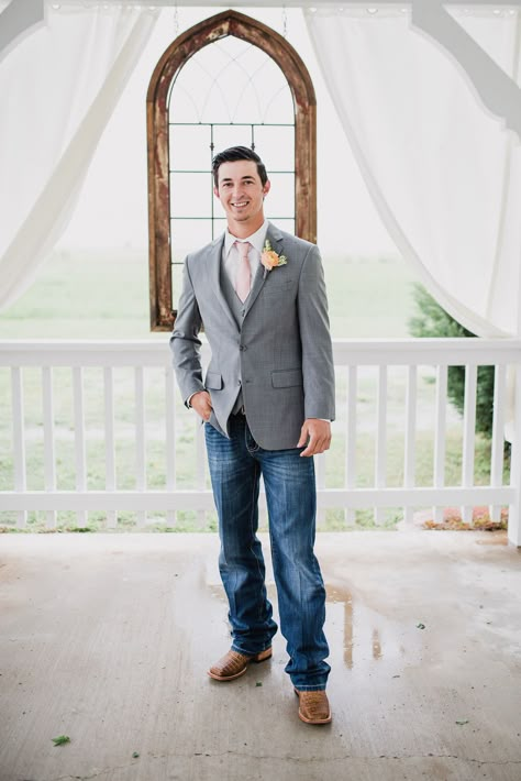 Groom wearing suit jacket and jeans with cowboy boots. Groom in gray suit jacket with boots.  Photo by: Rebecca Chesney Photo & Film Grey Jacket And Jeans Groom, Gray Suit Jacket With Jeans Wedding, Suit Jackets And Jeans Wedding, Tux With Jeans And Boots, Jeans And Sports Coat Wedding, Groom Outfit With Jeans, Country Groomsmen Attire Jeans, Suit And Jeans For Men Wedding, Grey Suit Jacket With Jeans Wedding