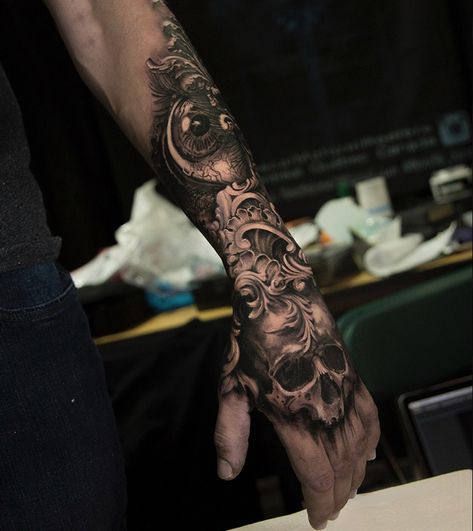 Stunning work in this human skull, eye and filigree piece, done on guy's hand & forearm by Pascal Malorni Reniere, an artist based in Montreal, Canada. Black And Grey Forearm Tattoo Men, Skull On Hand Tattoo Design, Filigree Hand Tattoo, Forearm Tattoo Piece, Men Skull Tattoos, Forearm And Hand Tattoo, Hand And Forearm Tattoo For Men, Skull Forearm Tattoo Men, Skull On Hand Tattoo