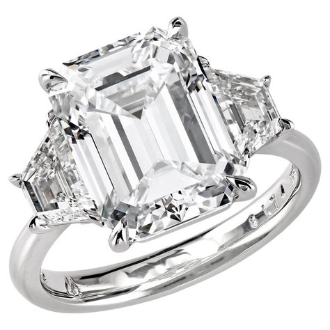 Emerald Engagement Ring With Side Stones, White Emerald Cut Three Stone Ring, Three Stone Emerald Cut Diamond Ring In Diamond White, Three-stone Diamond Emerald-cut Ring, Silver Emerald-cut Three Stone Diamond Ring, Emerald-cut Platinum Diamond Ring With Center Stone, Leon Mege, Ring With Emerald, Ring Cuts