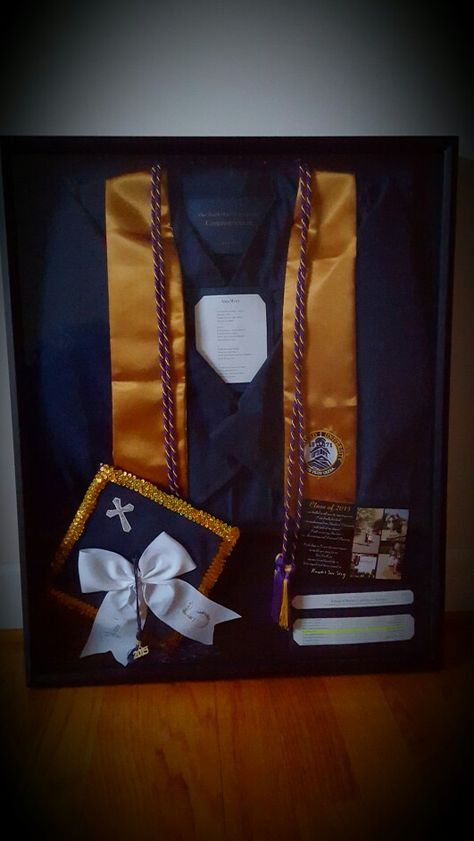 College graduation shadow box featuring cap, gown, cords, alma mater, graduation announcement, and name in the program Frame Graduation Cap And Gown, Cap And Gown Frame Ideas, Cap And Gown Shadow Box Ideas, Graduation Shadow Box College, Graduation Shadow Box Ideas, Shadow Box Graduation, Graduation Display, Senior Graduation Quotes, Graduation Box