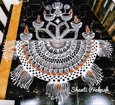 A simple mandala kolam designed with vilakku… Kolam inspired by Nurani temple kolam #kolam #kolambyshantiprakash Mandala Kolam, Temple Kolam, Vilakku Kolam, Kolam Art, Diwali Diya Decoration, Diya Decoration, Alpona Design, Kolam Design, Rangoli Side Designs