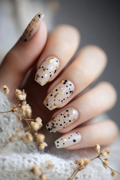 Click for More ➡️ | Save for Later ❤️ A sheer milky white base with tiny black and gold dots arranged in an abstract pattern creates a minimalist but stylish effect. (Minimal Dot Art - Short Nail Design Ideas)