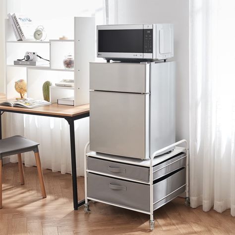 PRICES MAY VARY. Durable Steel Frame in White designed to hold your compact mini-fridge (up to 110lbs) 2 Light Gray Fabric Drawers with Pull Handle to hold cooking supplies, snacks, cups, plates, etc No tools required for assembly - Includes 4 caster wheels (2 with locking mechanisms) for easy movement Keeps your compact fridge off the ground to easily reach items, while providing additional storage for smart use of your space Overall Dimensions: 23.2"W x 22"D x 21.3"H Space in your apartment or Dorm Kitchen Essentials, Fridge Stand, Mini Fridge Stand, Dorm Kitchen, Compact Fridge, Grey Drawers, Light Gray Fabric, Dorm Furniture, Twin Xl Bedding