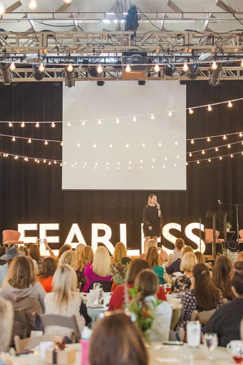 woman speaks on stage with FEARLESS sign behind her | Tennessee Women Connect Live Event at the Loveless Barn photographed by Nashville TN branding photographer Amy Allmand Photography. #AmyAllmandPhotography #TennesseeWomenConnect #NetworkingEvent Speak On Stage, Women Events Ideas, Women In Leadership Photography, Woman On Stage Speaking, Leadership Aesthetic Photography, Women Speaking On Stage, Woman Evolve Conference, Speaking Engagement Aesthetic, Female Speaker On Stage