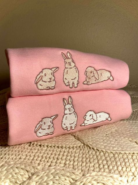 Introducing our Pink Bunny Embroidered Sweatshirt 2D Crewneck Sweatshirt, a must-have addition to your family’s wardrobe! This delightful sweatshirt combines comfort, style, and a touch of whimsy to create a truly unique and captivating piece. Let’s start with the design. Our Pink Bunny Embroidered Sweatshirt features a charming two-dimensional bunny embroidery that instantly adds a playful and adorable element to any outfit. The intricate details of the bunny, from its rosy cheeks t Crochet Bunny Sweater, Thumbnail Photo, Bunny Sweater, Bunny Sweatshirt, Bunny Halloween Costume, Embroidered Bunny, Embroidery Crewneck, Bunny Embroidery, Rosy Cheeks