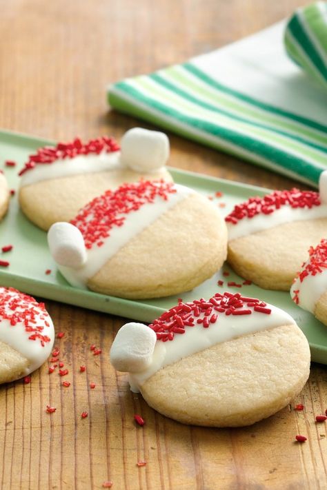 What an adorable way to get everyone in the holiday spirit! The super simple decorating instructions mean even the littlest kids can participate—Santa’s going to be extra excited when he sees these. Santa Hat Cookies, December Meals, Holiday Deserts, Winter Cakes, Decorate Cookies, Night Activities, Hat Cookies, Christmas Foods, Easter Baking