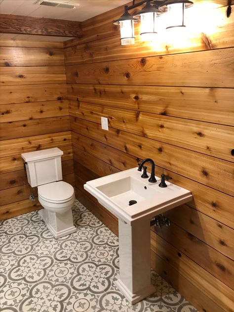 My beautiful bathroom! Best Husband Ever 💜 Cedar Shiplapped Walls, Cement Tile Floor (TileShop.com) with off white grout, 2X6 pine painted white shiplapped ceiling, light fixture above sink is from Menards for $100, toilet, sink and faucet are all Koehler. Cedar Walls Interior Bathroom, Pine Walls Bathroom, Cabin Bathroom Floor, Cedar Shiplap Wall, Adaptive Bathroom, Cedar Walls Interior, Cedar Bathroom Walls, Cedar Bathroom, Pine Shiplap Wall