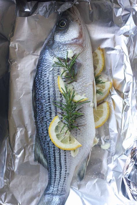 raw striped bass in foil before cooking Whole Striped Bass Recipe, Striped Bass Recipe Baked, Whole Sea Bass Recipes, Striped Bass Recipe, Striper Fish, Whole Fish Recipes, Cook Skins, Sea Bass Recipes, Fish Recipes Baked