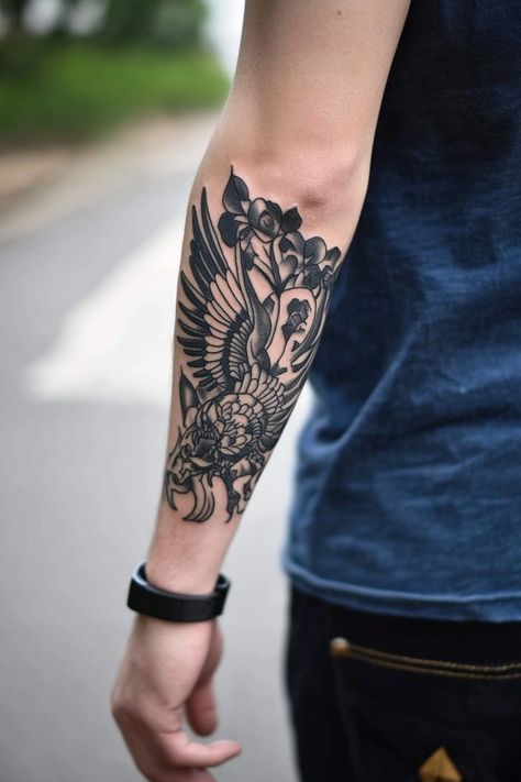 Forearm tattoo of a detailed bird design with flowers on a person wearing a dark blue shirt and a black wristband. Man Arm Tattoo, Arm Tattoo Inspiration, Arm Tattoo Design, Man Arm, Arm Tattoos For Men, Arm Tattoo Ideas, Compass Rose Tattoo, Celtic Knot Tattoo, The Perfect Man